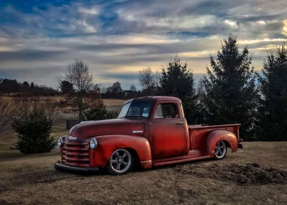 Red classic Chevy pickup in a landscape