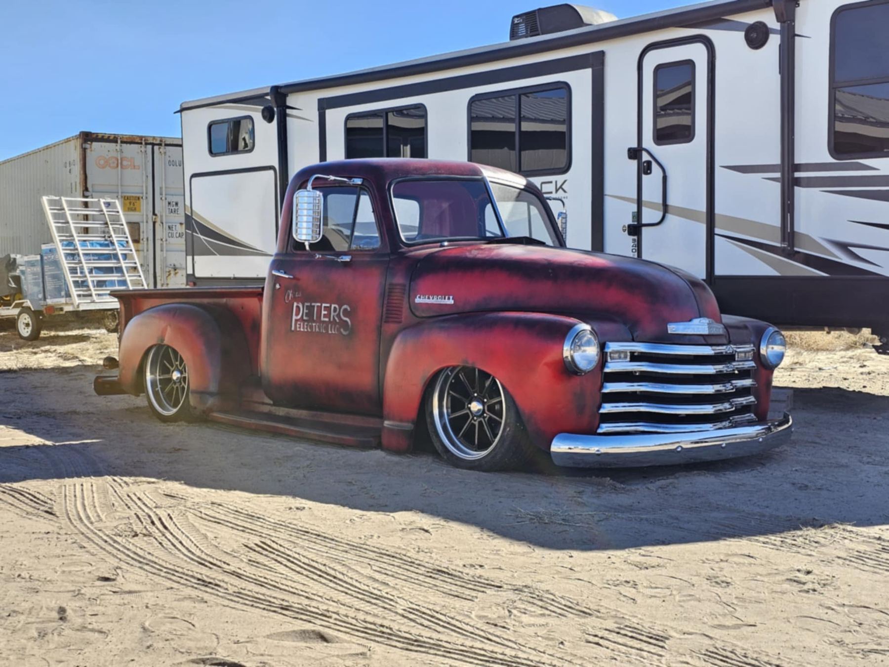 Red patina Chevrolet pickup with custom wheels